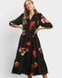 Woman wearing a black floral dress on a white background