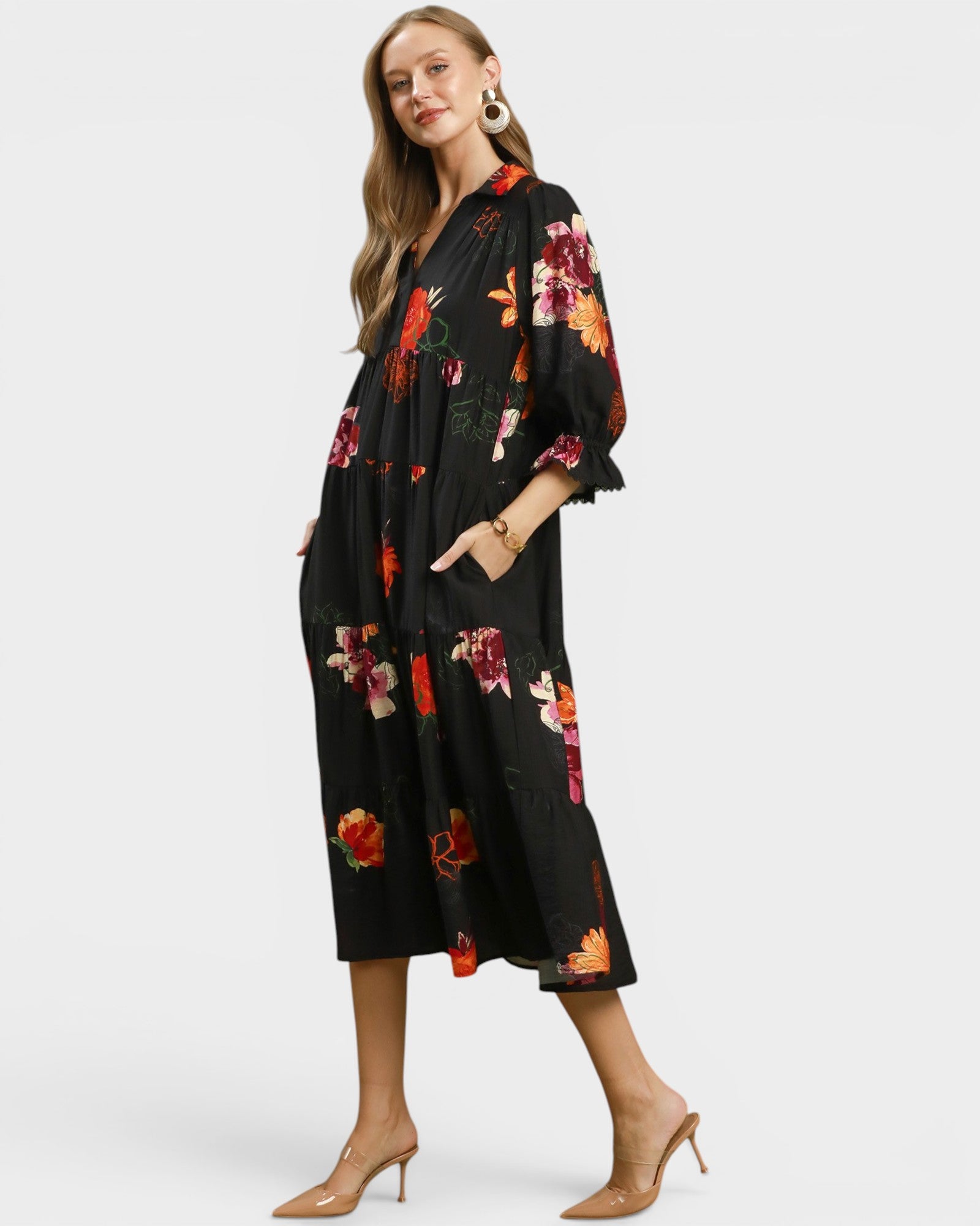Woman wearing a black floral kimono-style dress on a white background