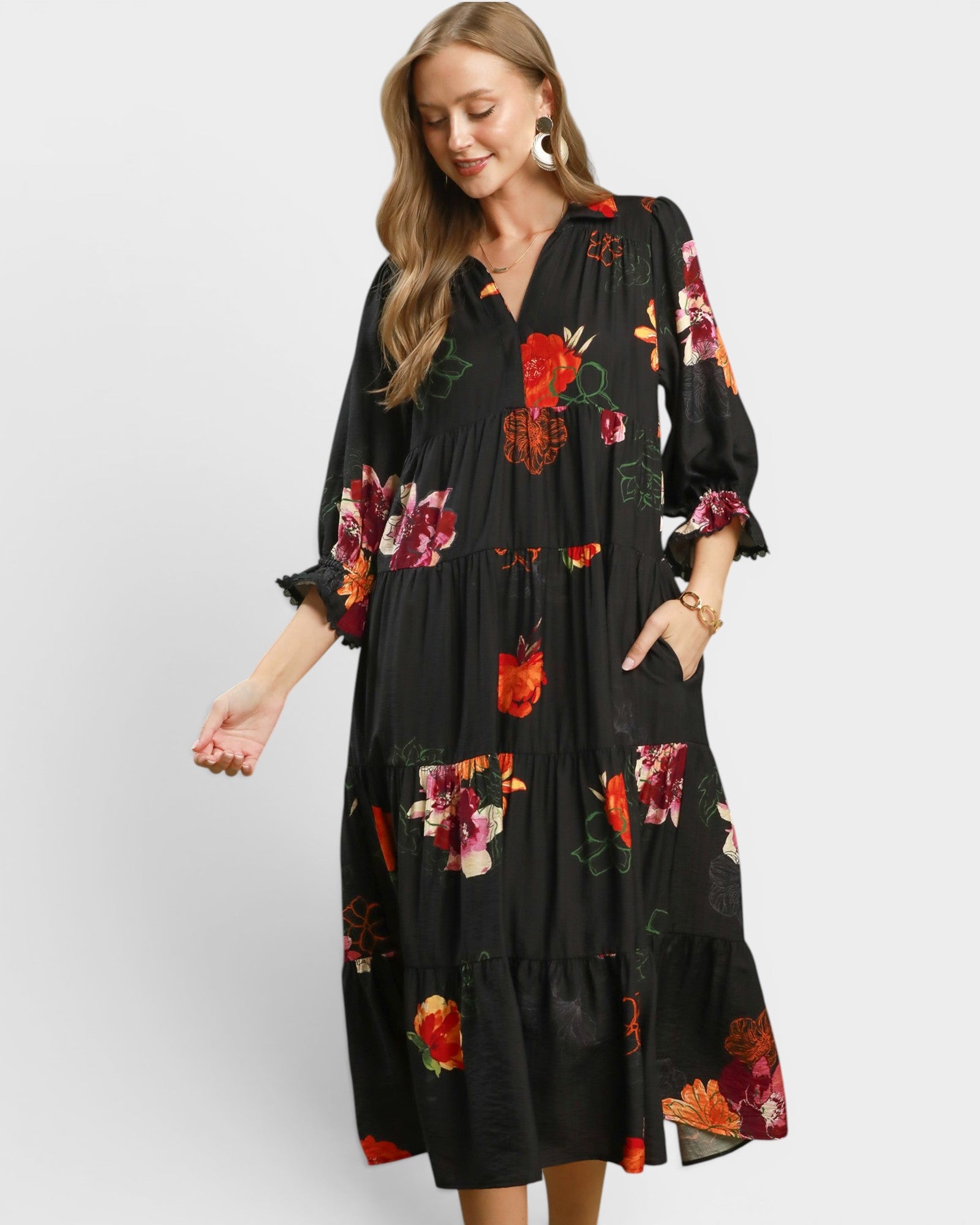 Woman wearing a black floral dress on a white background
