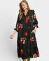 Woman wearing a black floral dress on a white background