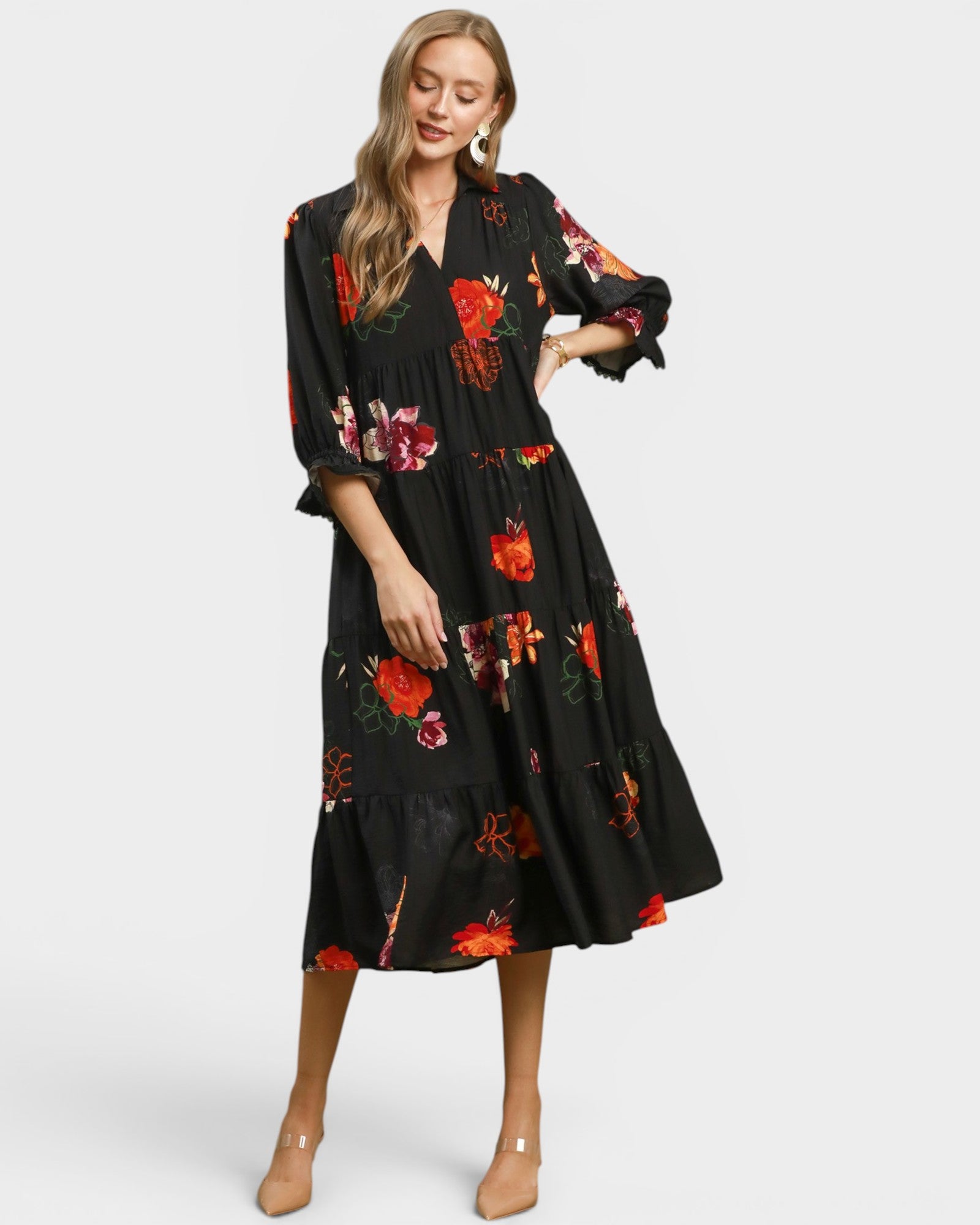 Woman wearing a black floral dress on a white background