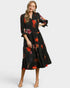 Woman wearing a black floral dress on a white background