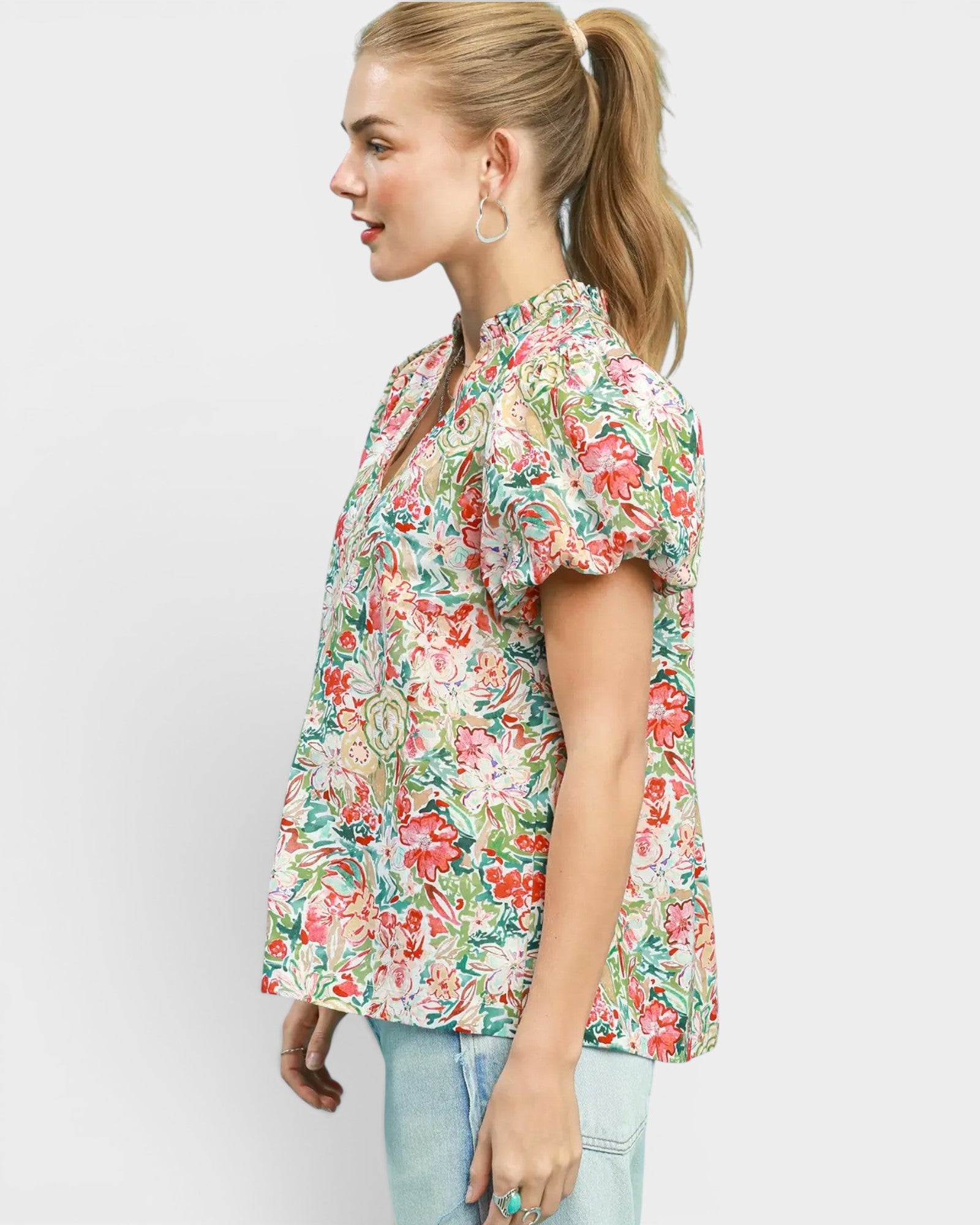 Woman wearing a floral blouse on a white background