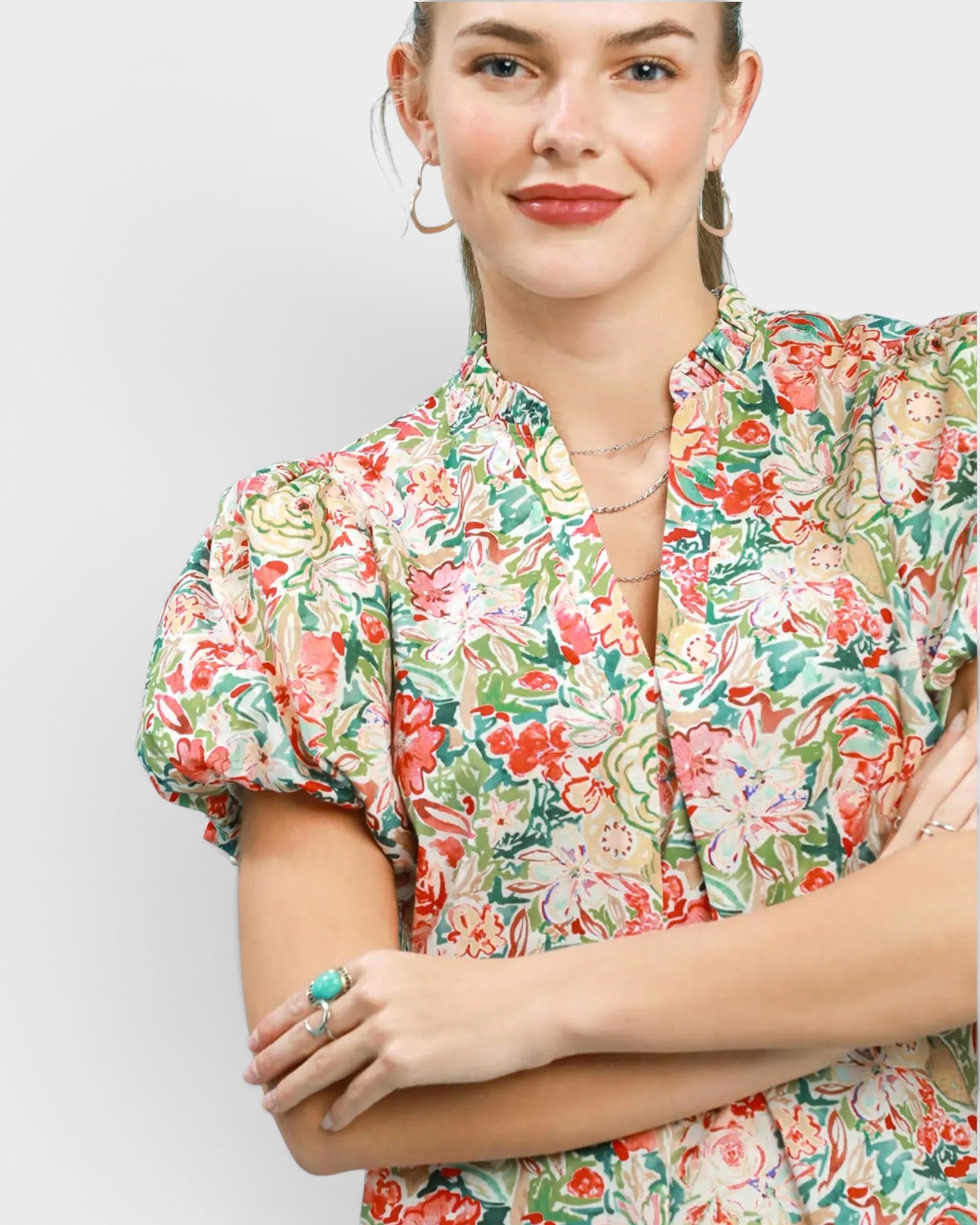 Woman wearing a floral blouse with a plain background
