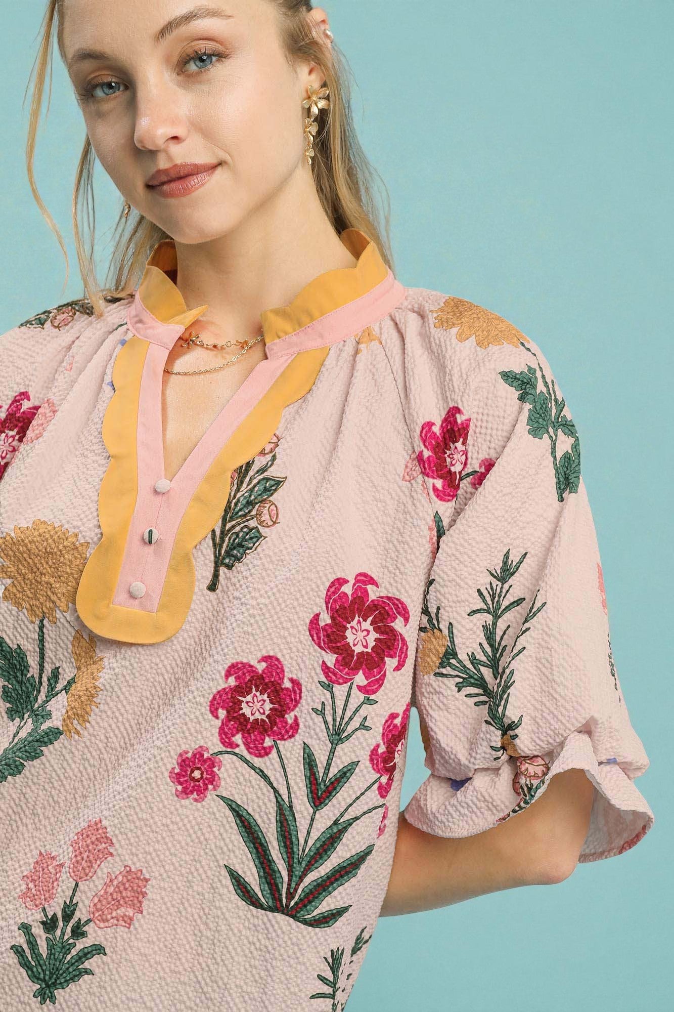 Woman wearing a floral dress with a light blue background
