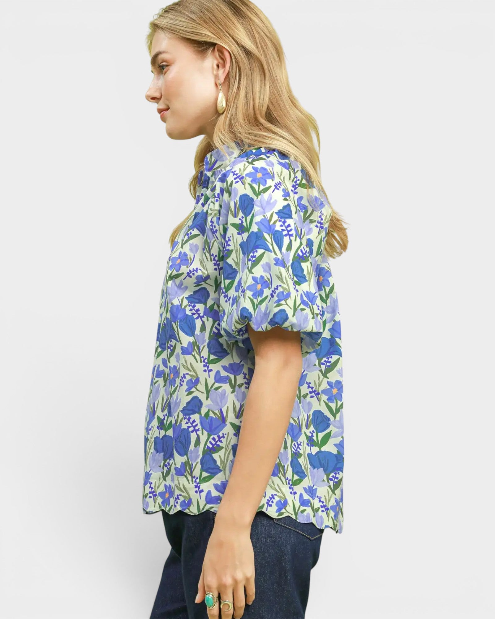 Woman wearing a blue floral blouse on a white background