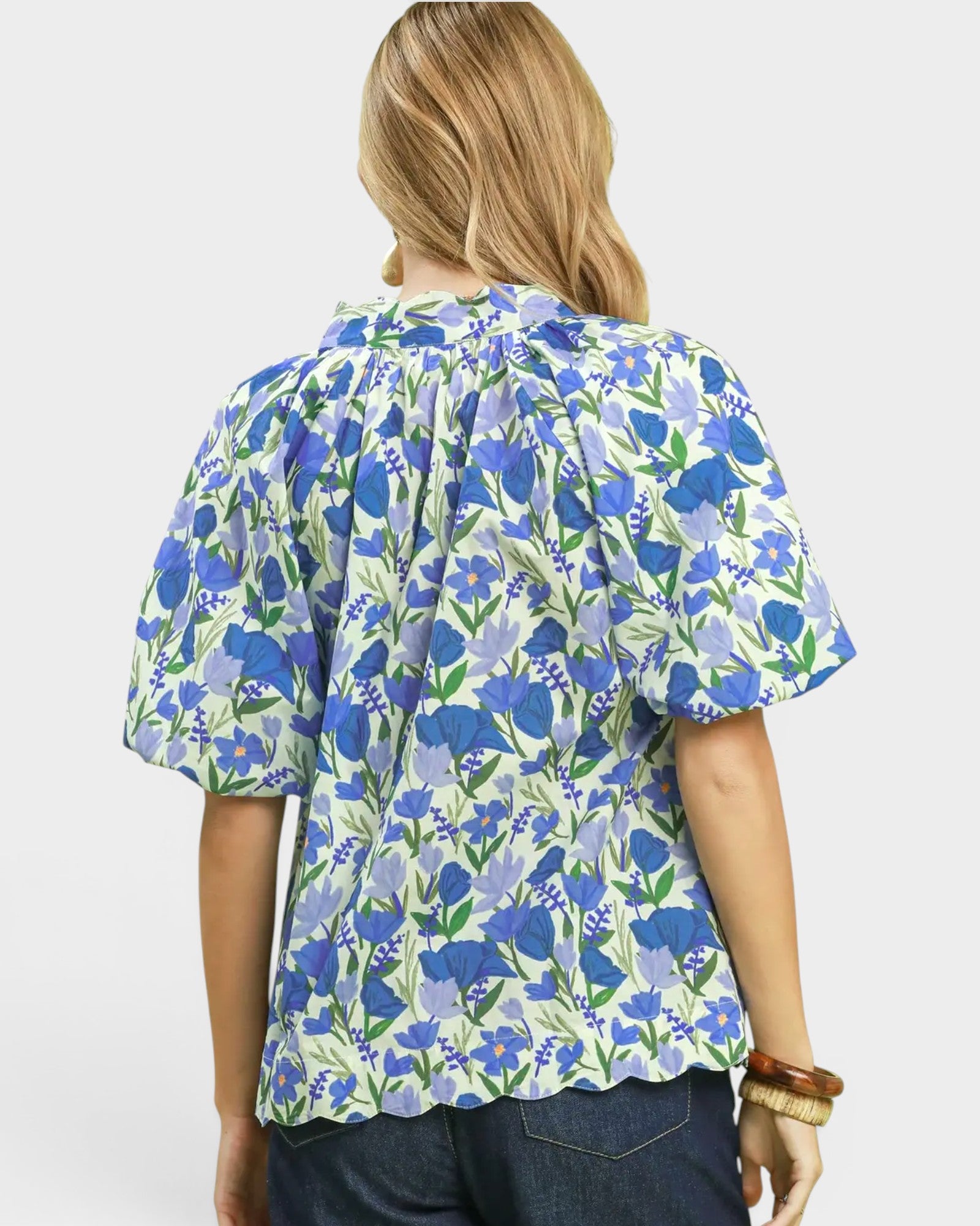 Woman wearing a blue floral blouse on a white background
