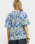 Woman wearing a blue floral blouse on a white background