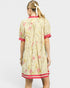 Woman wearing a floral dress with red accents on a white background