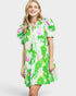 Woman wearing a green floral dress on a white background
