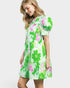 Woman wearing a green floral dress on a white background