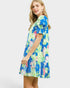 Woman wearing a colorful floral dress on a white background