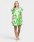 Woman wearing a green floral dress on a white background