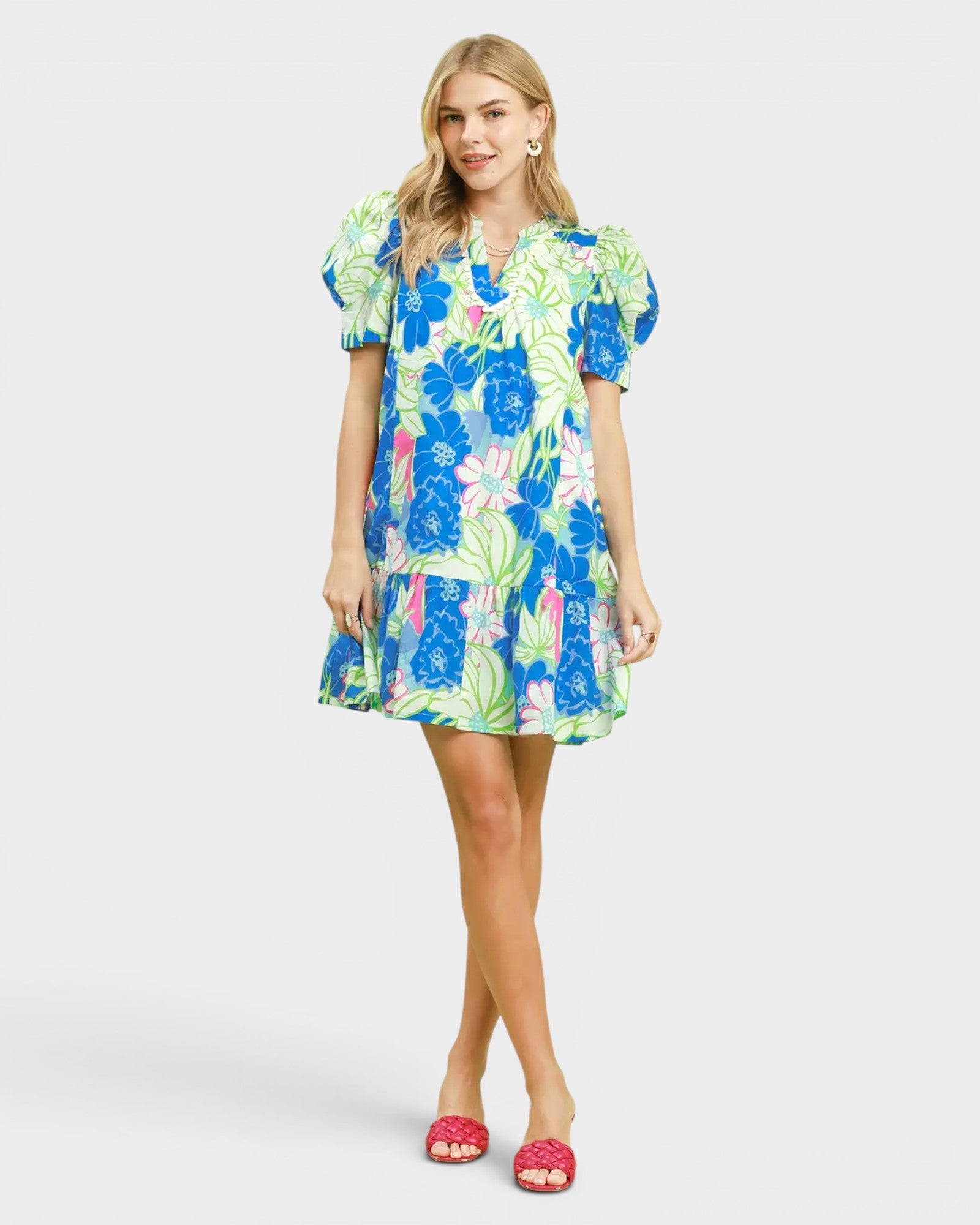 Woman wearing a colorful floral dress on a white background