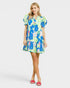 Woman wearing a colorful floral dress on a white background