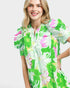 Woman wearing a colorful floral dress on a white background