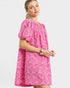 Woman wearing a pink floral dress on a white background