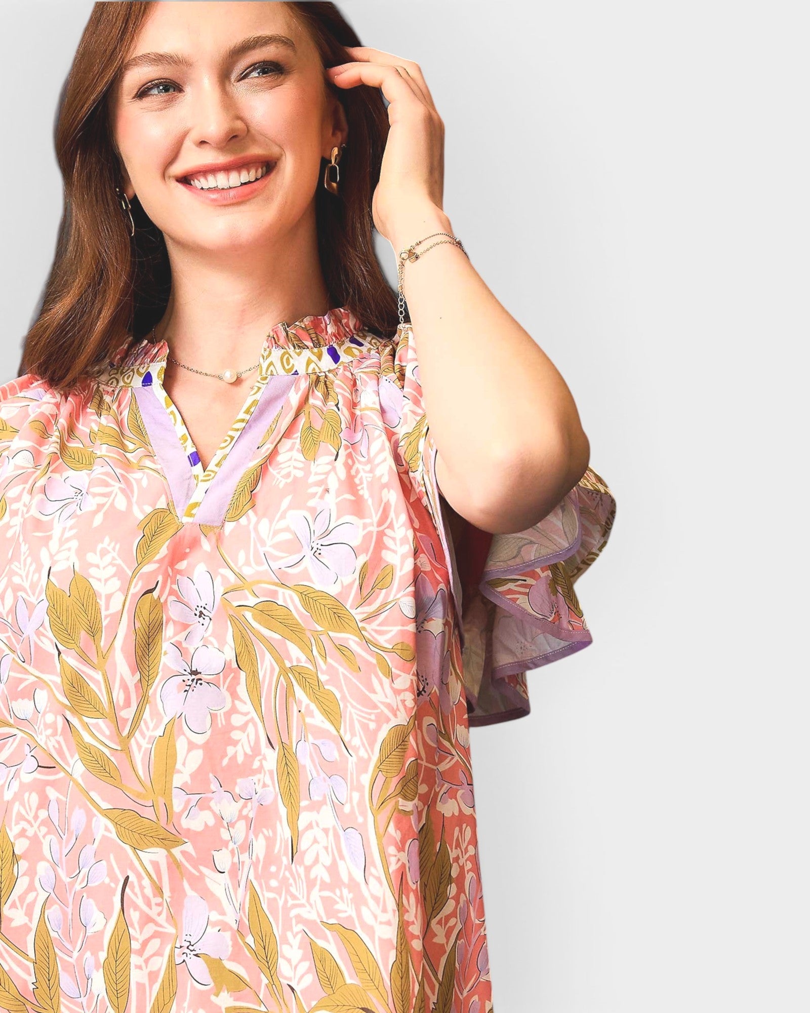 Woman wearing a floral dress with a plain background