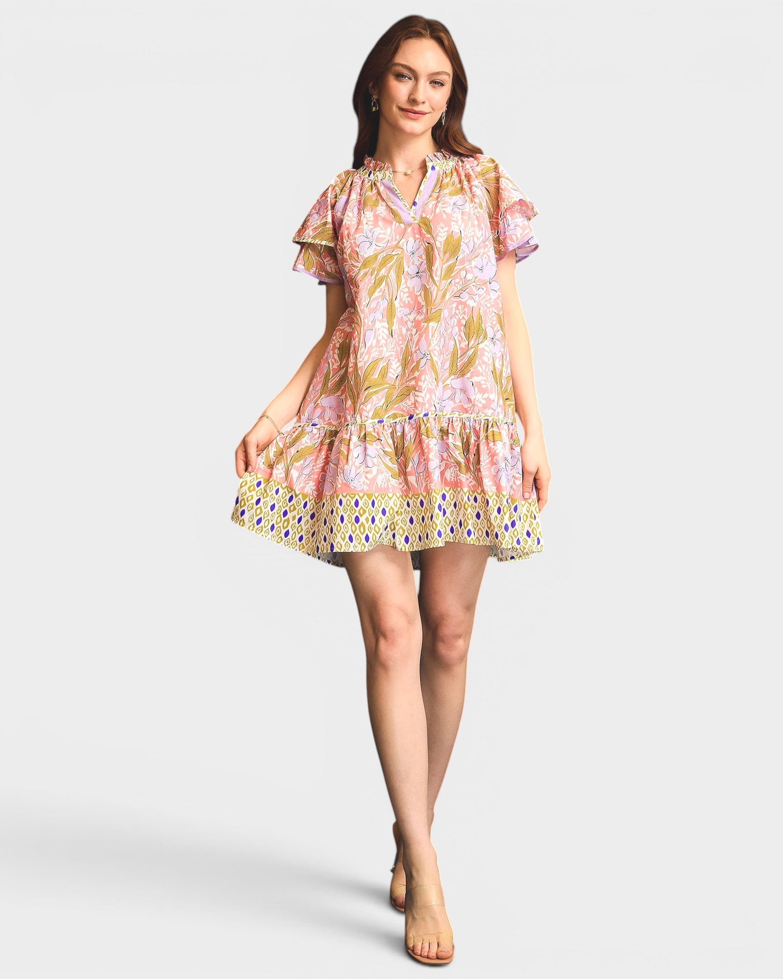 Woman wearing a floral dress on a white background