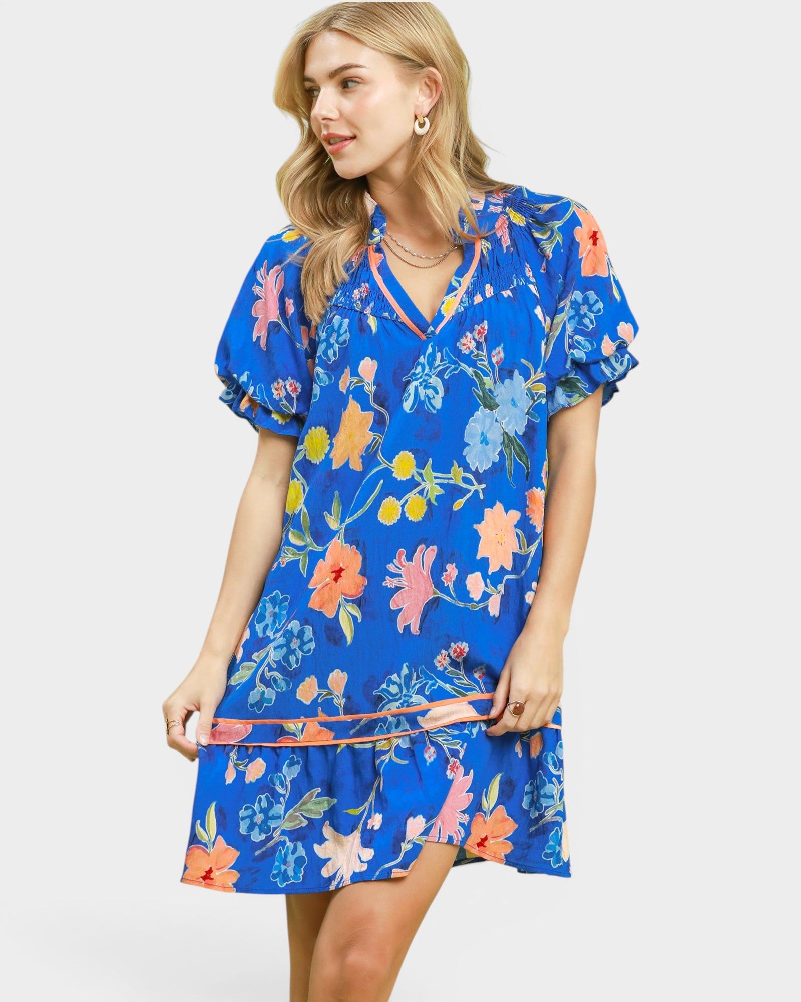 Woman wearing a blue floral dress on a white background