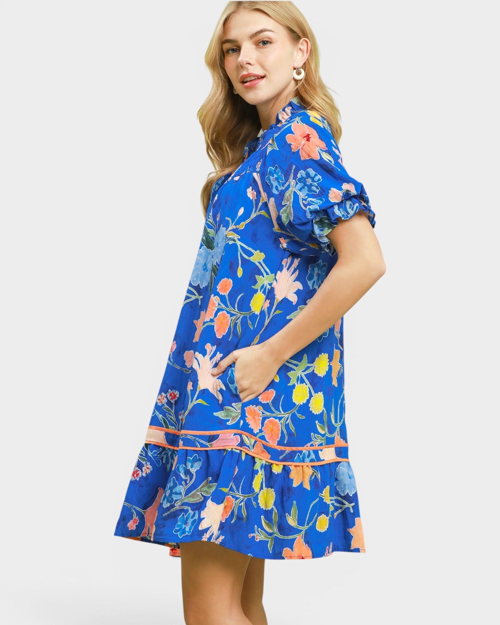 Woman wearing a blue floral dress on a white background