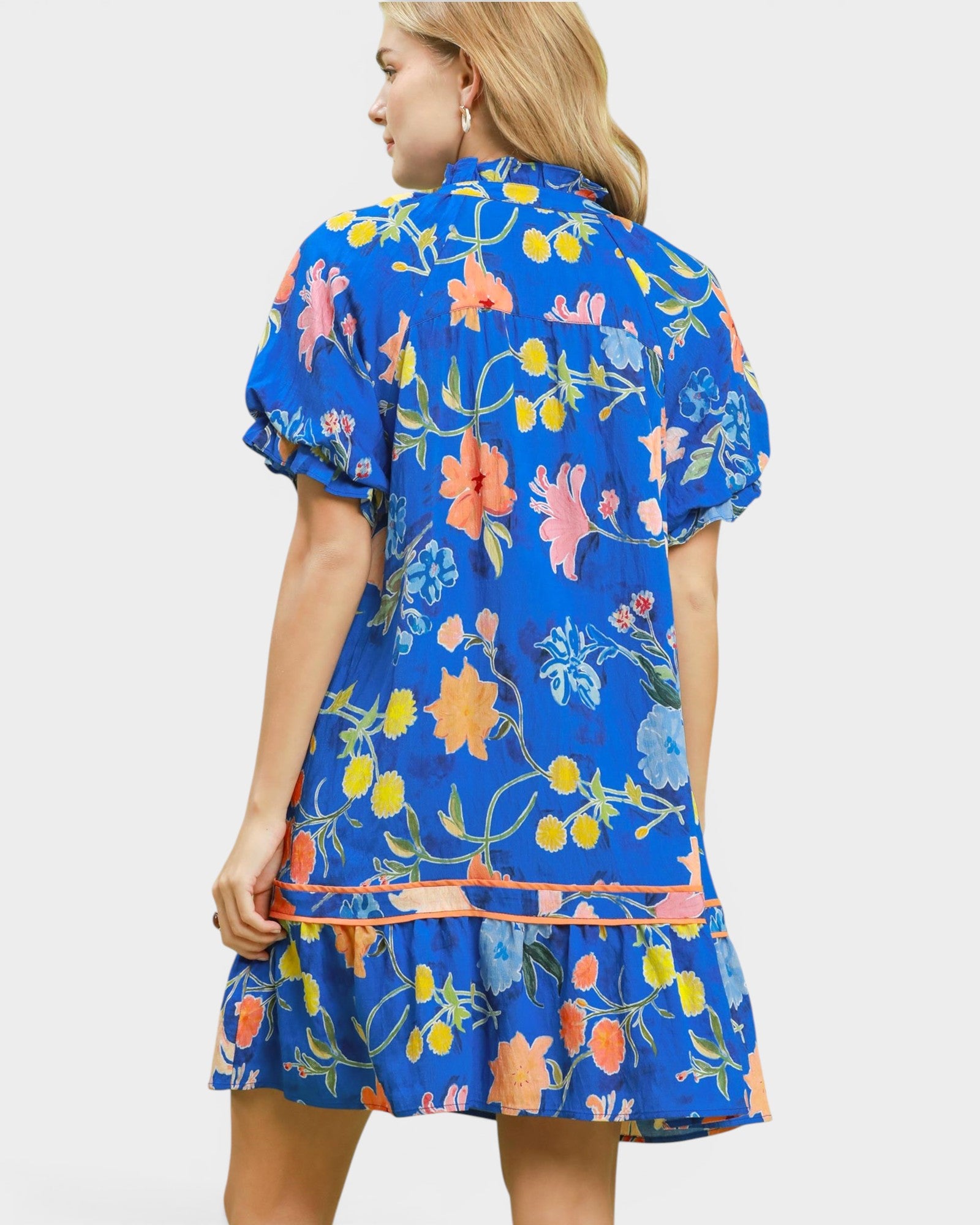 Woman wearing a blue floral dress on a white background