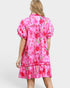 Woman wearing a pink floral dress on a white background