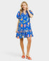 Woman wearing a blue floral dress on a white background