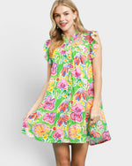 Woman wearing a colorful floral dress on a white background