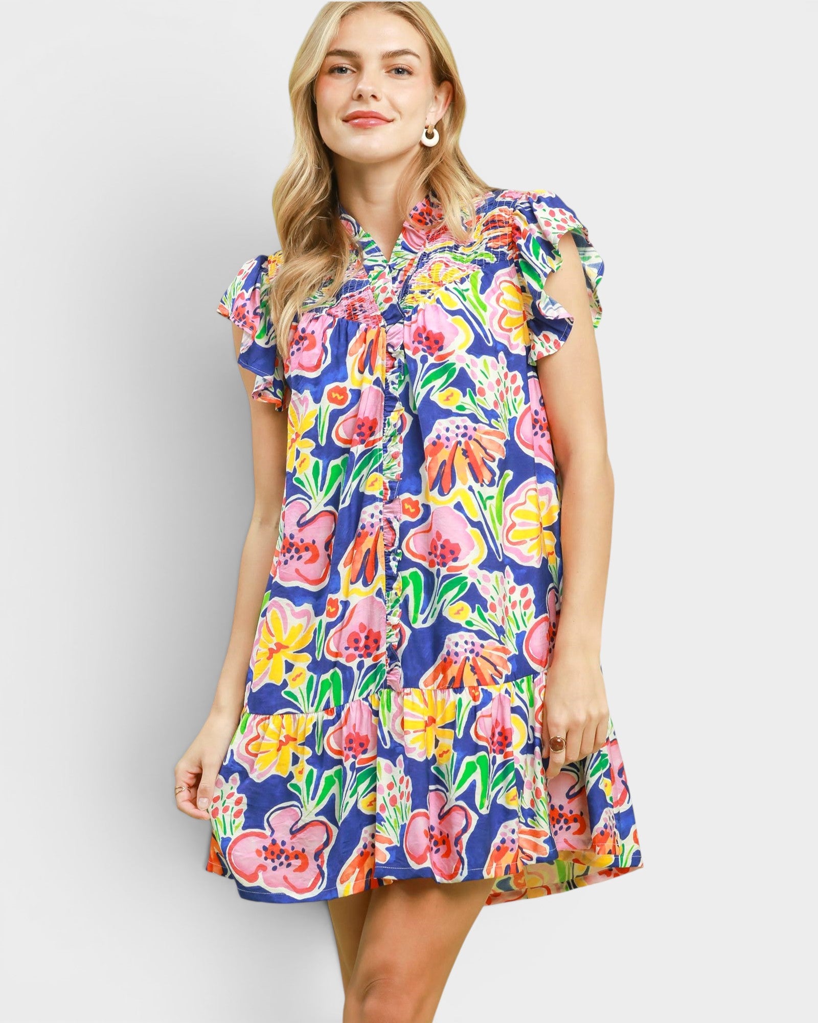Woman wearing a colorful floral dress on a white background