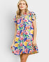 Woman wearing a colorful floral dress on a white background