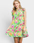 Woman wearing a colorful floral dress on a white background
