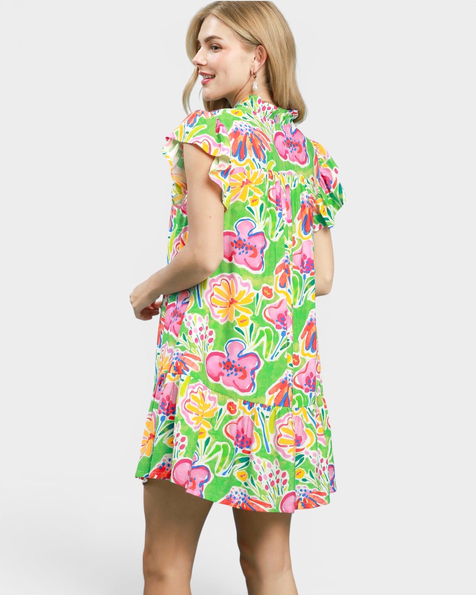 Woman wearing a colorful floral dress on a white background