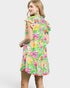 Woman wearing a colorful floral dress on a white background
