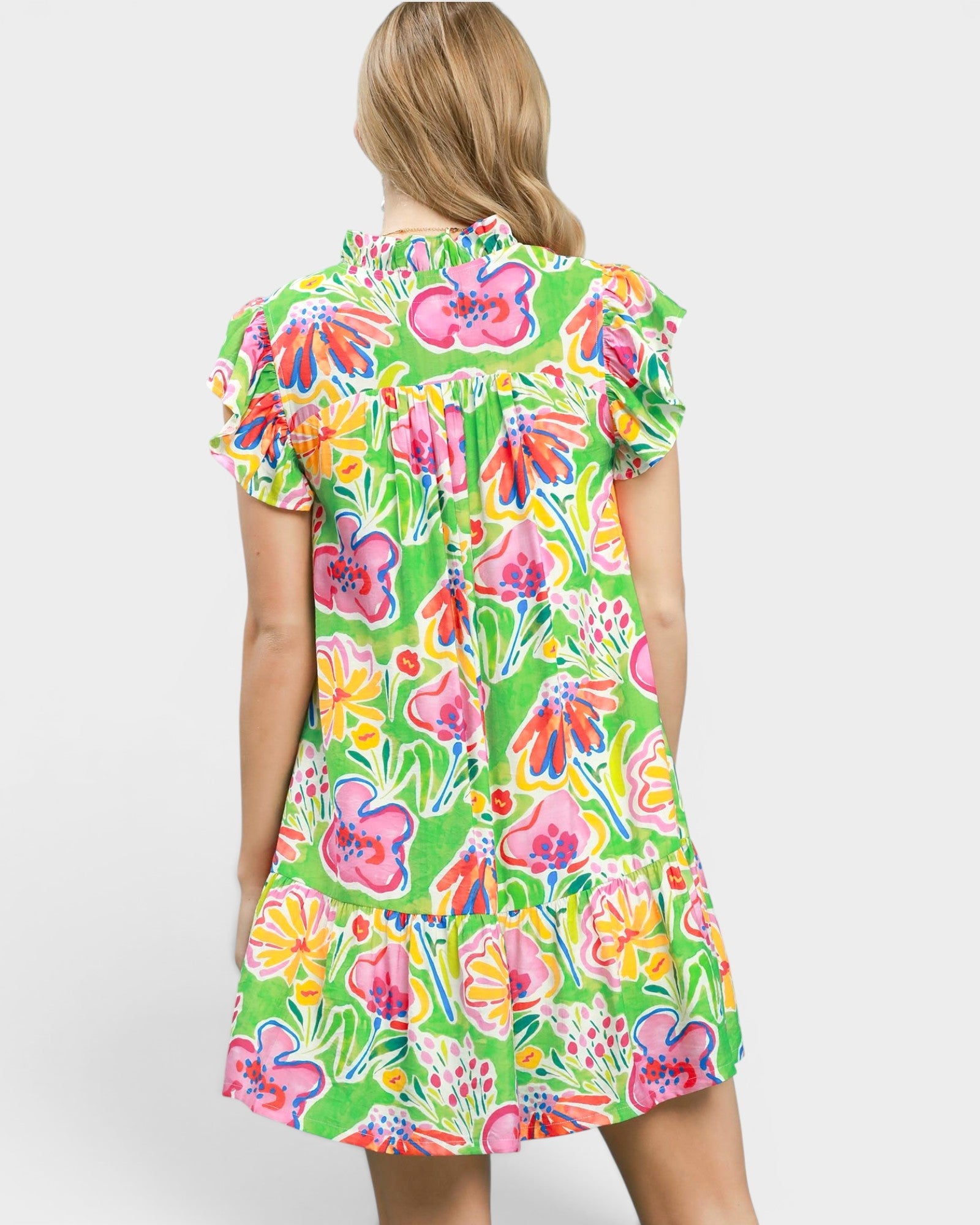 Woman wearing a colorful floral dress on a white background
