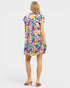 Woman wearing a colorful floral dress on a white background