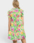 Woman wearing a colorful floral dress on a white background