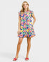 Woman wearing a colorful floral dress on a white background