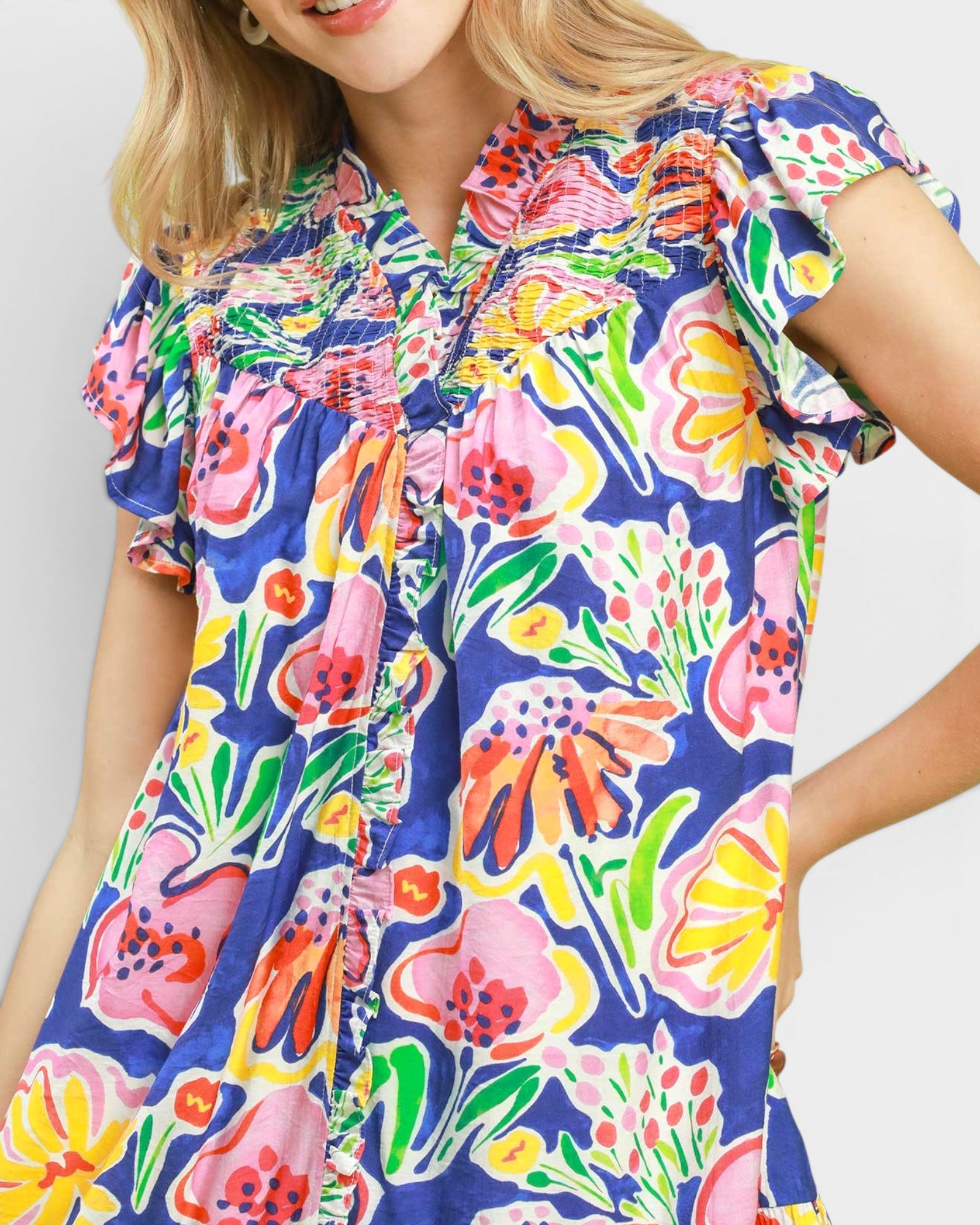 Woman wearing a colorful floral dress on a white background