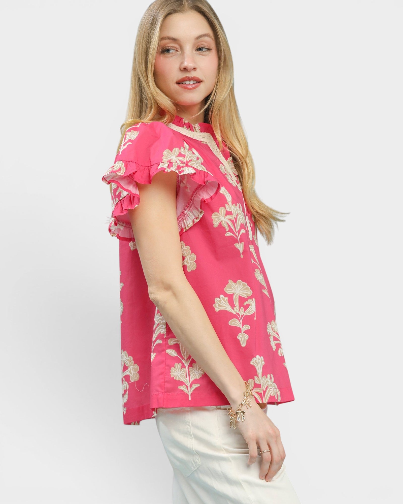 Woman wearing a pink floral blouse on a white background