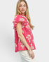 Woman wearing a pink floral blouse on a white background