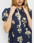 Navy blue dress with beige floral embroidery on a plain background