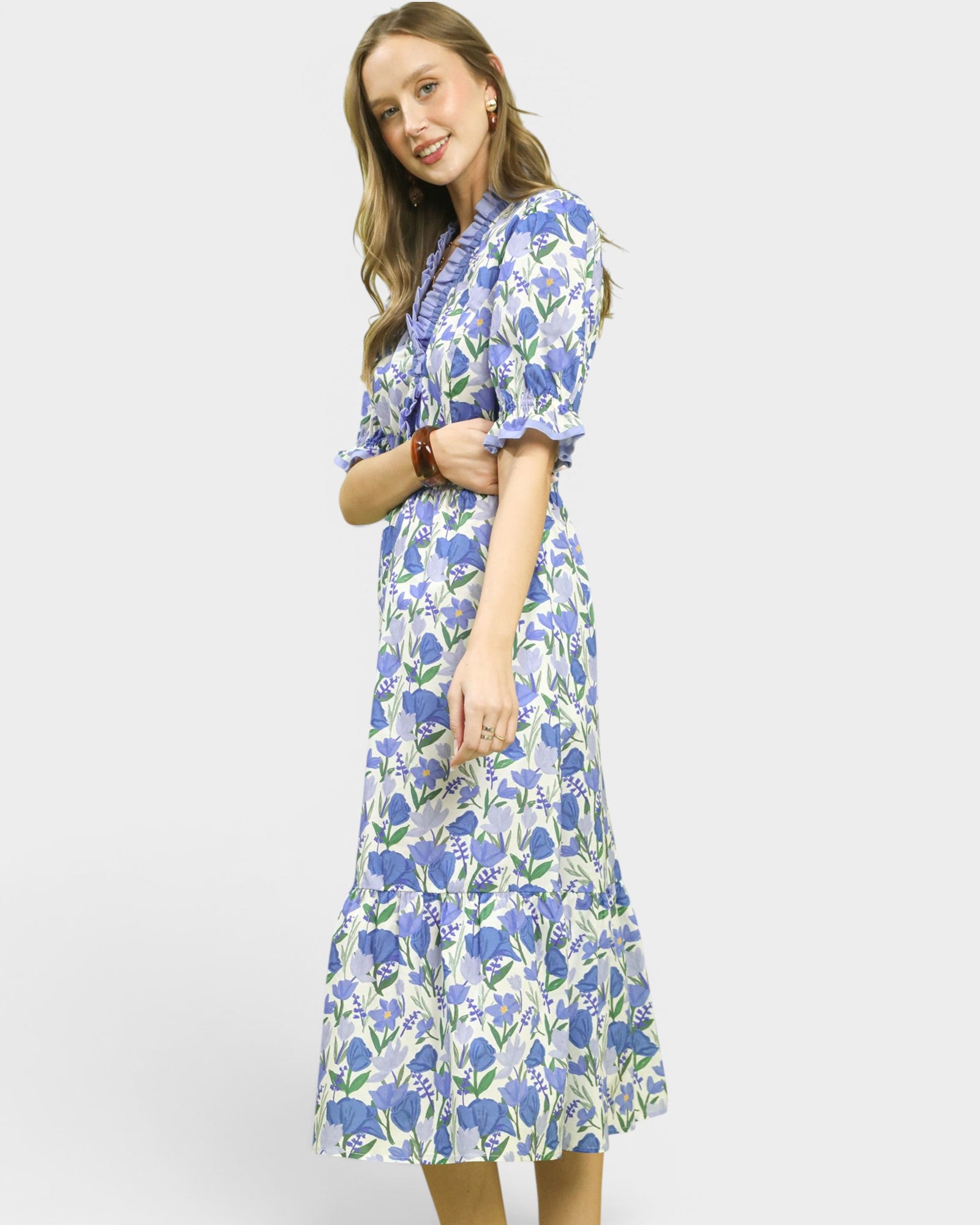 Woman wearing a blue floral dress on a white background