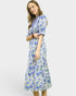 Woman wearing a blue floral dress on a white background