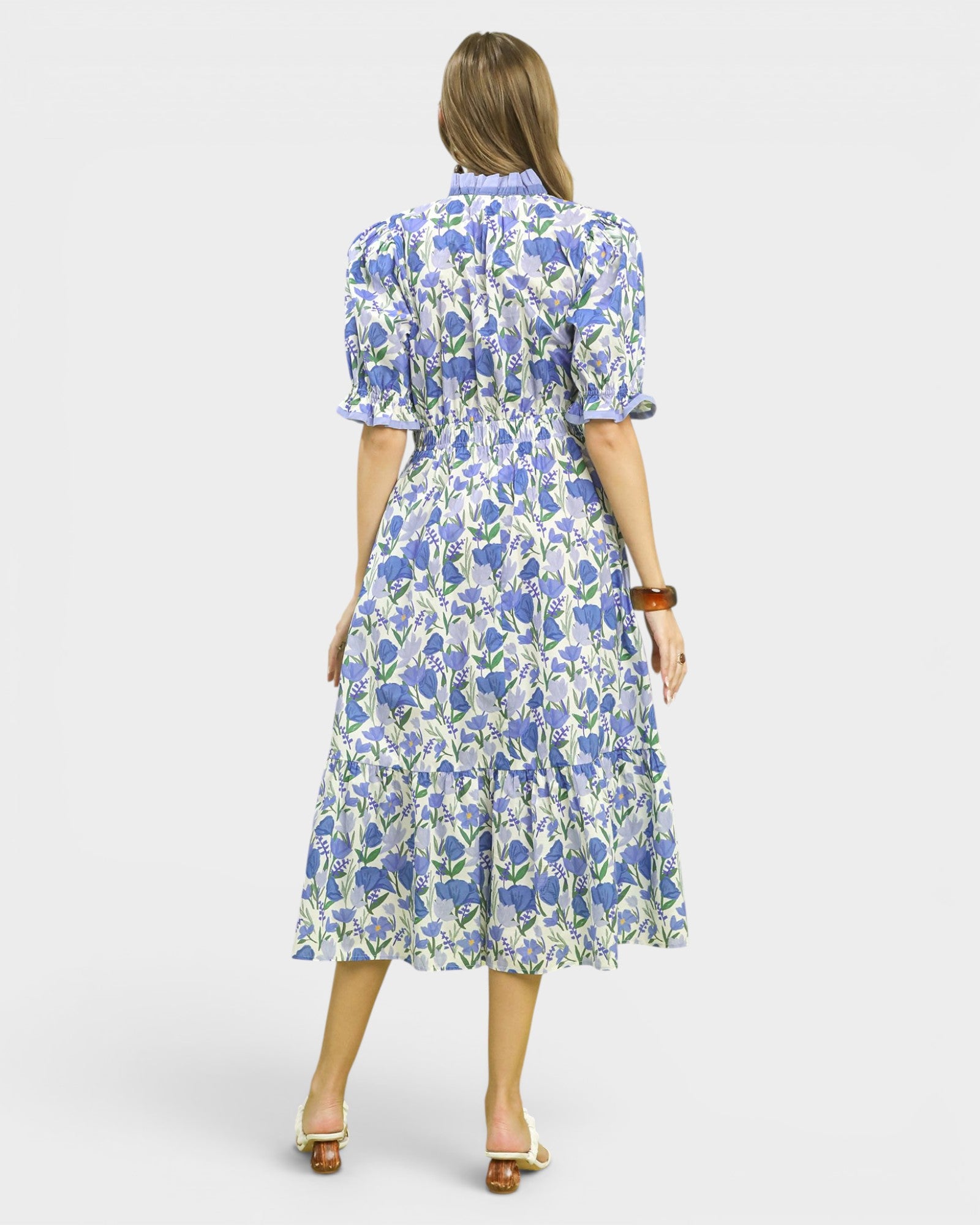 Woman wearing a floral dress on a white background