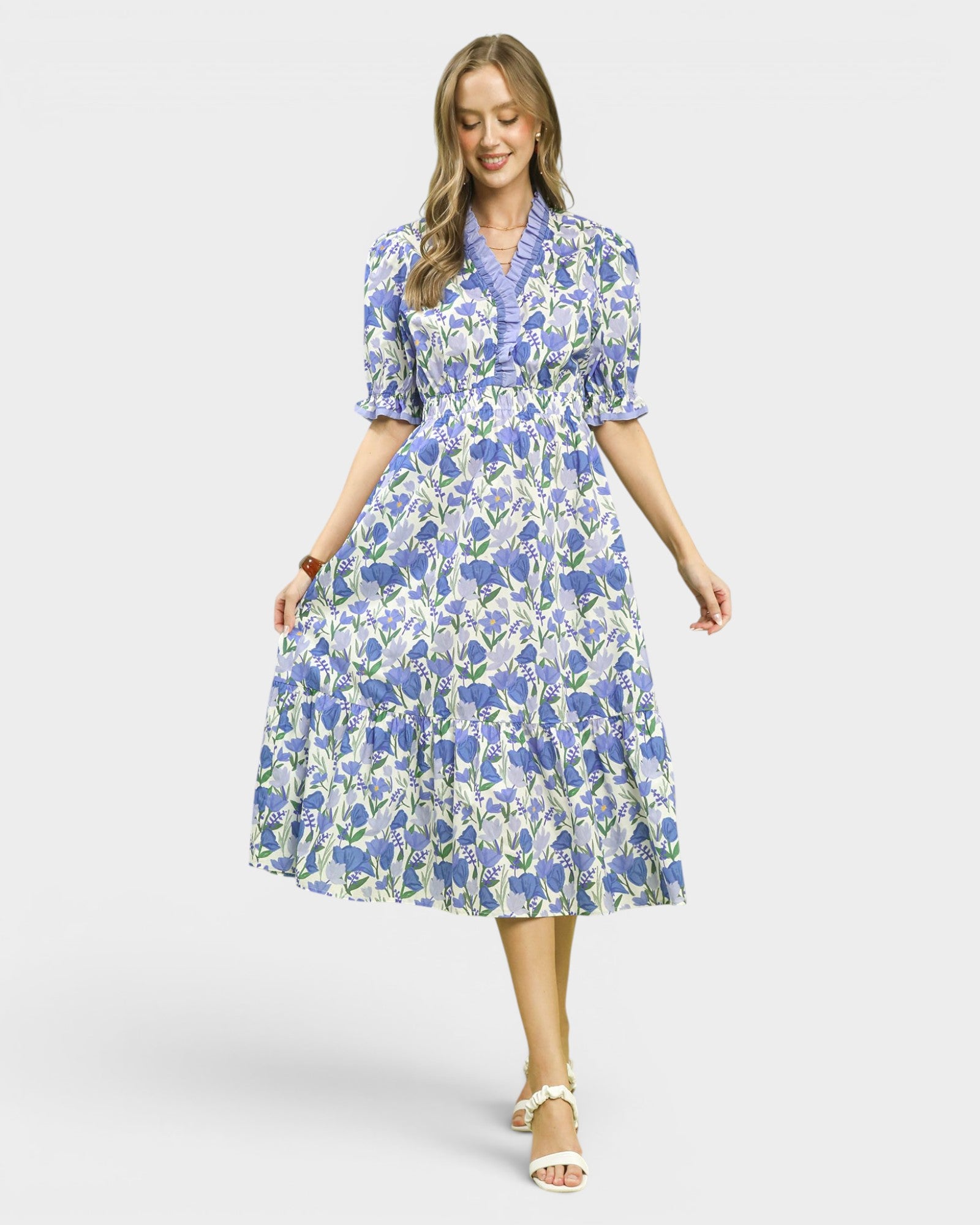 Woman wearing a blue floral dress on a white background