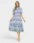 Woman wearing a blue floral dress on a white background