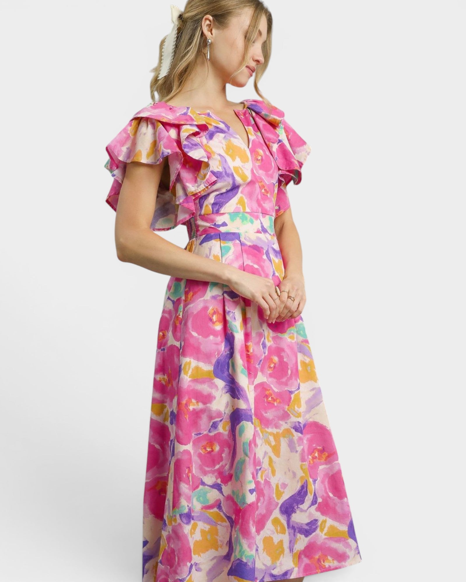 Woman wearing a colorful floral dress on a white background