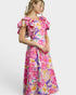 Woman wearing a colorful floral dress on a white background