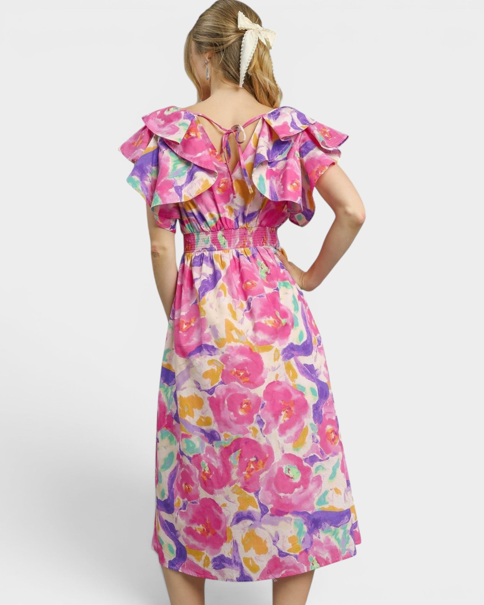 Woman wearing a colorful floral dress on a white background